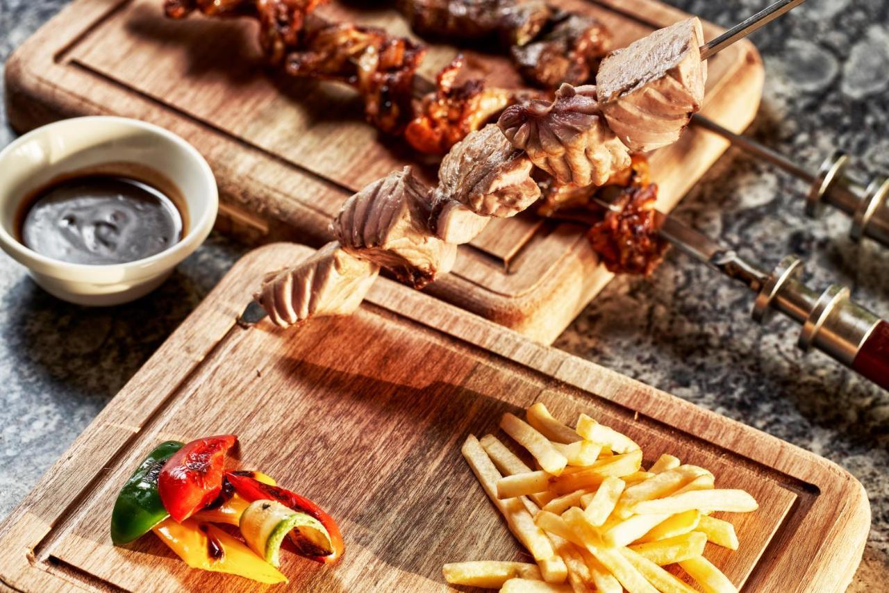 Fanar Hotel & Residences Salalah Esterno foto A wooden cutting board