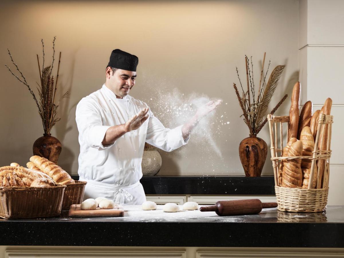 Fanar Hotel & Residences Salalah Esterno foto A baker preparing bread