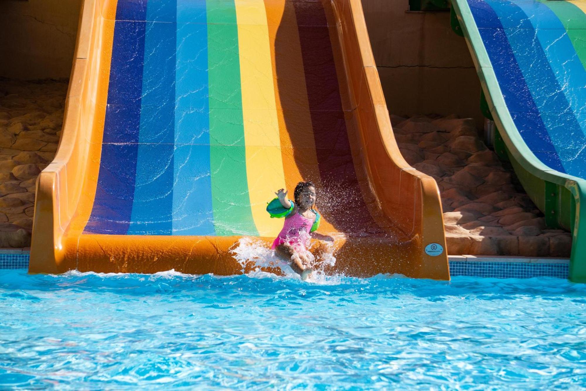 Fanar Hotel & Residences Salalah Esterno foto A child on a water slide